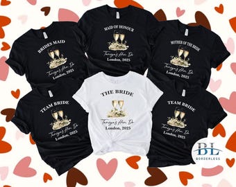 May include: Six black t-shirts with white text and graphics. The shirts say "Brides Maid", "Team Bride", "Maid of Honour", "Mother of the Bride", "The Bride", and "Team Bride". Each shirt has a graphic of two champagne flutes with a floral design. The text on each shirt also includes "Taniya's Hen Do" and "London, 2025".