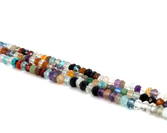 May include: A strand of colorful gemstone beads, including amethyst, aquamarine, citrine, and garnet. The beads are faceted and have a polished finish.