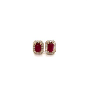 May include: A pair of rectangular stud earrings featuring a deep red ruby center stone surrounded by a halo of small, clear, round-cut diamonds set in a yellow gold metal frame. The earrings have a classic, symmetrical design with a polished finish.