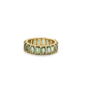 May include: A gold ring featuring a continuous band of rectangular, light green gemstones. The ring's band is a warm gold color, and the gemstones are evenly spaced around the entire circumference of the ring.