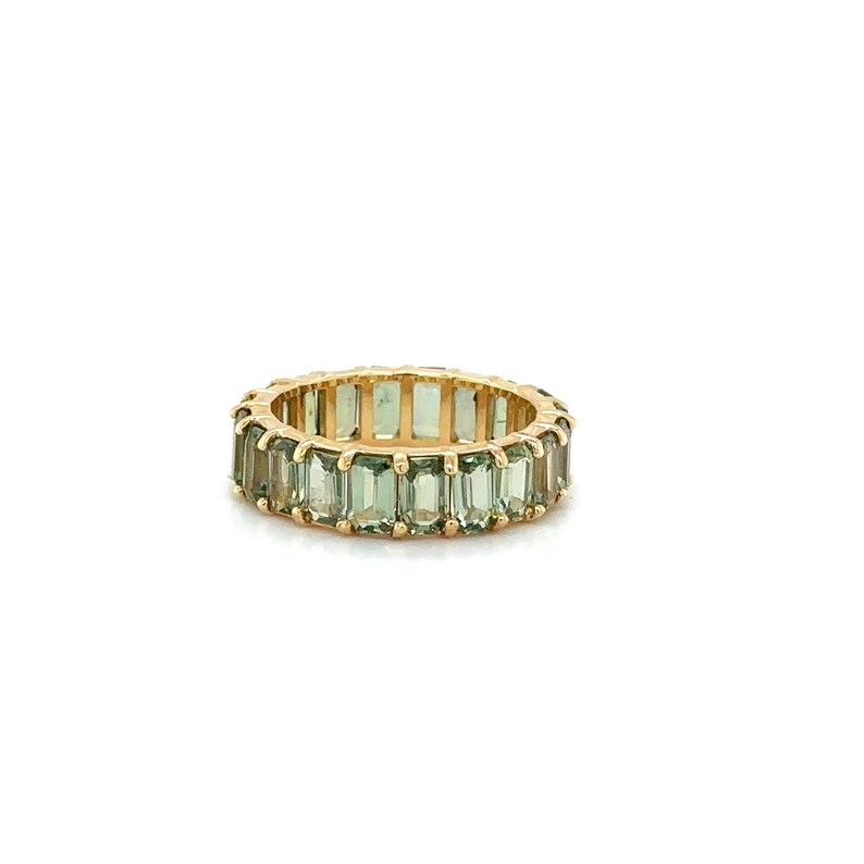 May include: A gold ring featuring a continuous band of rectangular, light green gemstones. The ring's band is a warm gold color, and the gemstones are evenly spaced around the entire circumference of the ring.