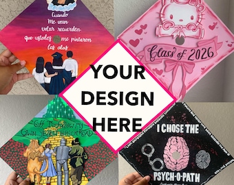May include: Four graduation caps with unique designs. One features a painting with text in Spanish, another has a Hello Kitty design with "Class of 2026", a third depicts the Yellow Brick Road, and the last one says "PSYCH-O-PATH 2025".