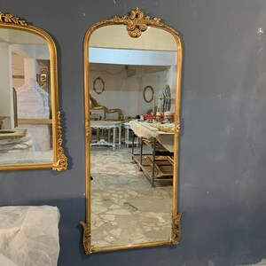 A wooden plate mounted as a mold on the back of the mirror to strengthen the mirror. This does not affect the weight of the mirror much, the gilded French style mirror is light enough to be carried easily, HANGING BRACKETS ATTACHED on the back.