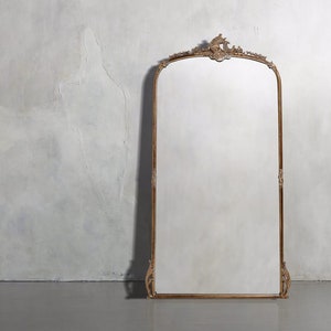 The Gilded Anthropologie Mirror is an exquisite example of craftsmanship that is both beautiful and convenient. Made from solid linden and hornbeam wood.