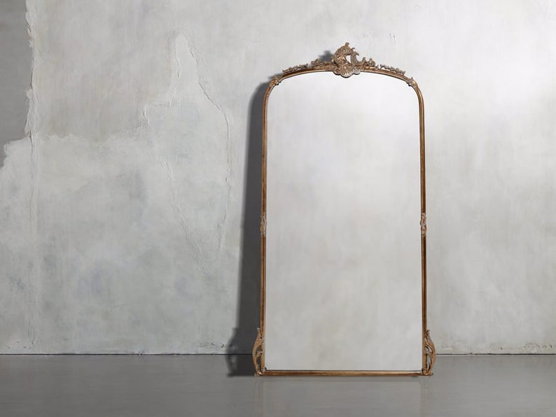 The Gilded Anthropologie Mirror is an exquisite example of craftsmanship that is both beautiful and convenient. Made from solid linden and hornbeam wood.