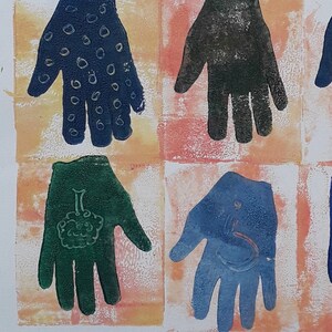 May include: A collection of 16 hand prints, each with a different design, are displayed on a white background. The hand prints are in shades of blue, green, and black. The designs include a star, a heart, a skull, a circle, and a swirl.