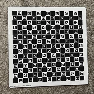 May include: A white square with a black and white checkerboard pattern of small squares. The squares contain various black and white shapes. Text at the bottom reads "30mm squares, 22mm markers, 15x15, 4x4".