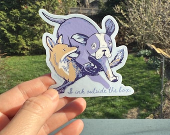 Lazy dog is not lazy! She jumps over quick red fox. A sticker to celebrate thinking (and fountain pen inking) outside the box.