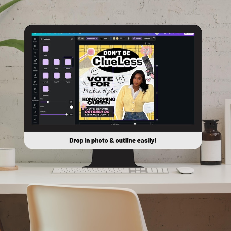 May include: A computer monitor displays a graphic design with the text "DON'T BE Clueless" and "VOTE FOR Malia Kyle HOMECOMING QUEEN". The design features a photo of a woman in a yellow cardigan. The screen also shows a design program interface.