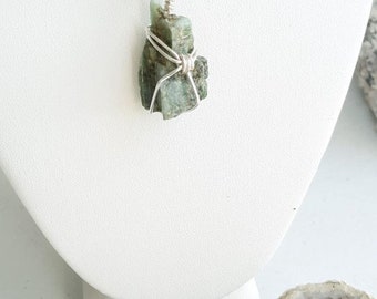Natural Raw Emerald Crystal wrapped with Sterling Silver, comes with an 18" Black Bolo Necklace