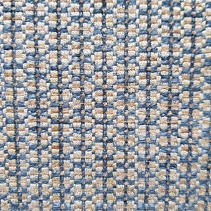 May include: A close-up of a woven fabric with a checkered pattern in shades of blue and beige.