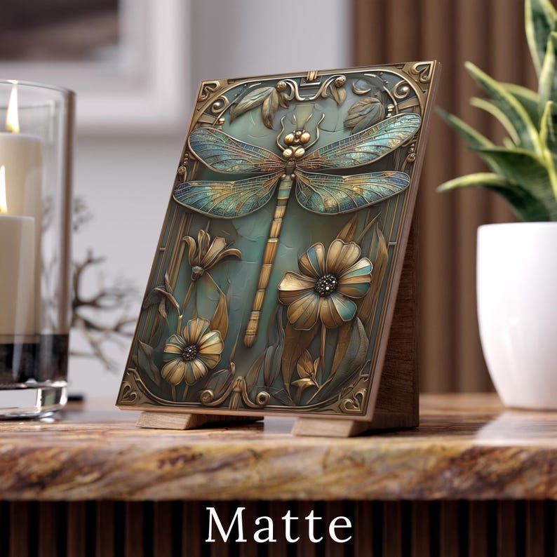 May include: A decorative wooden plaque featuring a dragonfly and floral design. The plaque has a teal background with bronze-colored accents. The word "Matte" is printed at the bottom of the plaque.