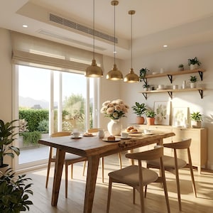 May include: A dining room featuring a wooden table with a meal set out. Three gold pendant lights hang above the table. The room has a large window overlooking a green outdoor space. Wooden chairs surround the table, and a buffet is against the wall.