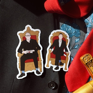 May include: Two illustrated figures, each wearing a suit and glasses, are sitting on ornate gold chairs with red cushions. The figures are on a black background with a red and blue patterned fabric and a gold sword.