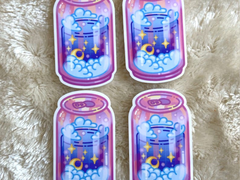 May include: Four stickers of a pink and purple can with a blue liquid inside. The liquid has a crescent moon, stars, and clouds inside. The can has a white outline.