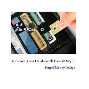 May include: A black leather wallet with multiple credit cards inside. The cards are secured with colorful fabric tabs with eyelets. The tabs are pulled to easily remove the cards. The text "SimpleTabs by Design" is below the image.
