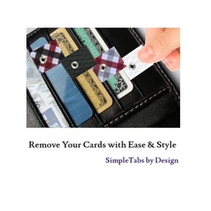 May include: A close-up of a black leather wallet with multiple credit cards inside. The cards are secured with colorful tabs that have a hole punched in the center. The tabs are red and black plaid, gray and black plaid, and white. The text "SimpleTabs by Design" is visible below the wallet.