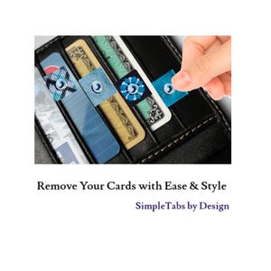 May include: A black leather wallet with multiple credit cards inside. Blue and white tabs with a small circle design are attached to the cards to make them easier to pull out.