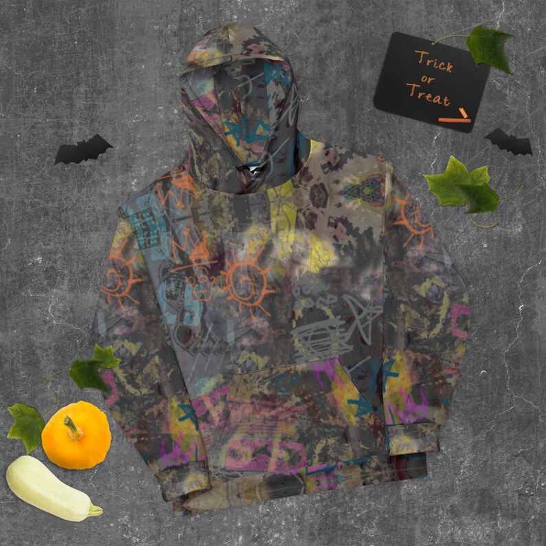 May include: A gray hoodie with a colorful abstract print featuring graffiti-style designs. The hoodie has a drawstring hood and a kangaroo pocket.