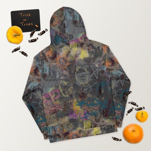 May include: A black hoodie with a colorful graffiti print. The print features a variety of shapes, lines, and words, including "Love" and "Peace".