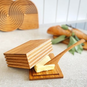 Butter dish for butter with natural wood spatula.