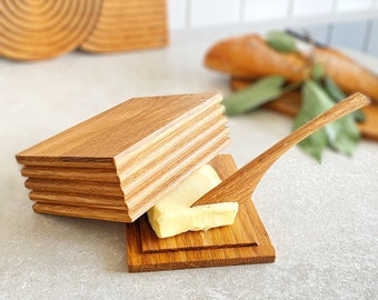 Butter dish for butter with natural wood spatula.