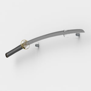 May include: A silver katana sword mounted on a white wall with clear acrylic wall mounts. The sword is curved and has a black handle.