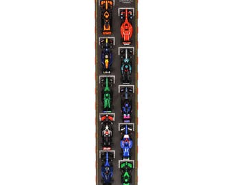 May include: A vertical poster featuring a grid of 2024 Formula 1 race cars. The cars are arranged in a grid pattern, with each car facing upwards. The cars are all different colors, including red, blue, green, black, and orange. The poster has a black background with a white checkered pattern.