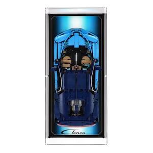 May include: A blue and black Lego model of a Bugatti Chiron, viewed from above. The model is displayed in a clear acrylic case with a black background and the word "Chiron" printed in red at the bottom.
