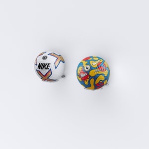 May include: Two footballs, one white with the Nike logo and the words "Nike" and "Strike", and the other a colourful design with red, yellow, blue, and black.