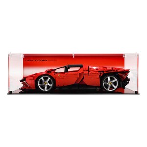 May include: A red Ferrari Daytona SP3 Lego model displayed in a clear acrylic display case with a black base. The case has a red background with the text "DAYTONA SP3" printed on it.