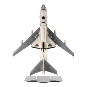 May include: A white and grey model aeroplane with extended wings, a tail, and the word "USA" printed on the side. The model is on a grey stand and appears to be made of interlocking blocks.