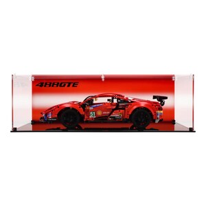 May include: A red Ferrari 488 GTE race car model in a clear acrylic display case with a black base. The car has black wheels, a black spoiler, and a black and white racing stripe. The case has a red background with the text "488GTE" printed on it.