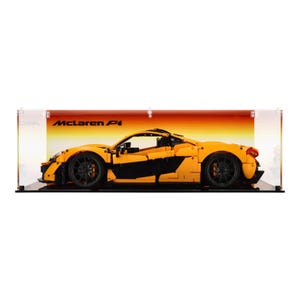May include: A yellow Lego model of a McLaren P1 car in a clear display case with a black base. The car is on a red and orange background.