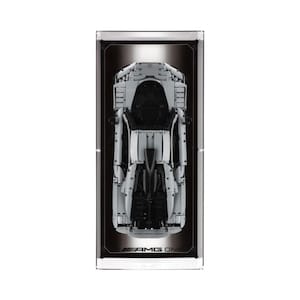 May include: A white and black model car, AMG ONE, presented in a clear rectangular case. The car is a detailed replica, showcasing its design. The case has a black background and a silver frame. The text "AMG ONE" is visible at the bottom.