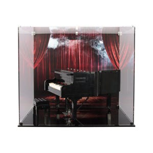 May include: A black grand piano model made of LEGO bricks is displayed in a clear acrylic display case. The piano is set against a backdrop of red velvet curtains with smoke effects.
