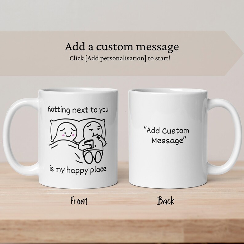 May include: Two white ceramic mugs. The front mug has a black and white cartoon couple with the text "Rotting next to you is my happy place." The back mug has the text "Add Custom Message."