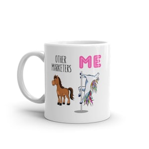 May include: White ceramic mug with the text "OTHER MARKETERS" and "ME". The mug features a cartoon horse and a unicorn pole dancing. The word "ME" is in pink.