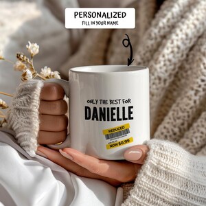 May include: White ceramic mug with the text "ONLY THE BEST FOR DANIELLE" in black. A yellow "REDUCED" sticker is on the mug. The top of the mug reads "PERSONALIZED FILL IN YOUR NAME".