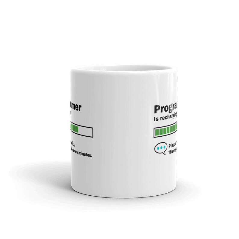 May include: White ceramic mug with a black and green progress bar graphic that reads "Programmer is recharging... Please wait several minutes."  The progress bar is almost full.  A blue speech bubble with three dots is below the progress bar.