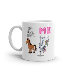 May include: White ceramic mug with a pink "ME" and a unicorn on a pole on the right side. The left side says "Other Aerospace Engineers" with a brown horse.