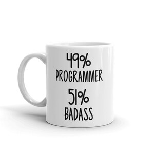 May include: White ceramic coffee mug with black text that reads "49% Programmer 51% Badass".