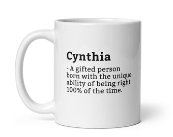 May include: White ceramic mug with the name "Cynthia" printed in black, along with a definition: "A gifted person born with the unique ability of being right 100% of the time."