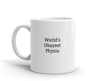 May include: White ceramic coffee mug with black text that reads "World's Okayest Physio".