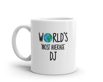 May include: White ceramic mug with a black graphic that says "World's 'Most Average' DJ" with a small blue and green globe graphic above the text.