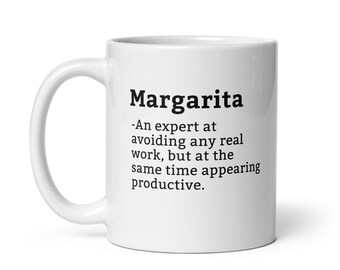 May include: White ceramic coffee mug with a black text design that reads "Margarita - An expert at avoiding any real work, but at the same time appearing productive."