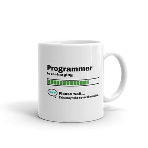 May include: White ceramic mug with a black and green graphic of a progress bar that reads "Programmer is recharging... Please wait... This may take several minutes."
