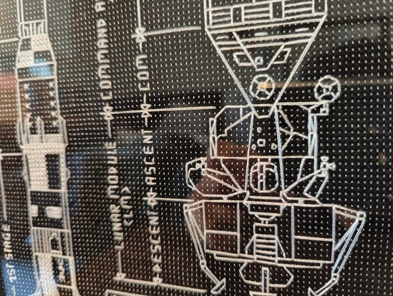 K&ouml;nnte beinhalten: Ein Schwarzwei&szlig;diagramm des Apollo 11-Mondmoduls mit dem Text "LUNAR MODULE - COMMAND MODULE" und "DESCENT - ASCENT - COM - XO".