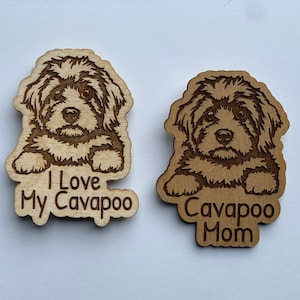 May include: Two wooden Cavapoo dog-themed cutouts. One cutout reads "I Love My Cavapoo" and the other reads "Cavapoo Mom". The cutouts feature a detailed engraving of a Cavapoo dog.