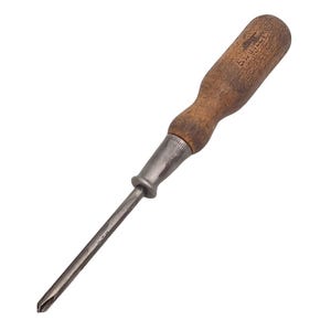 May include: A vintage Phillips head screwdriver with a wooden handle. The handle is a light brown colour and shows signs of wear. The metal shaft is a dark grey colour. The screwdriver is angled diagonally across a white background.